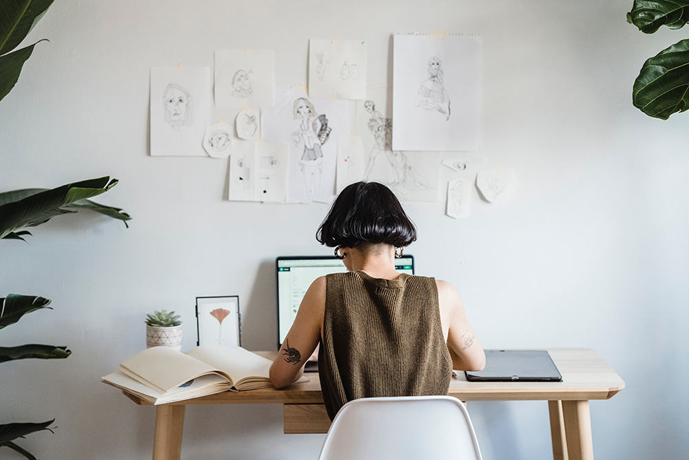 woman at desk working on laptop